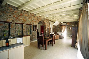 The sitting room, dining room and kitchen run across the full width of the house