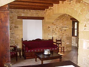 A large salon/sitting/dining room with open fire place